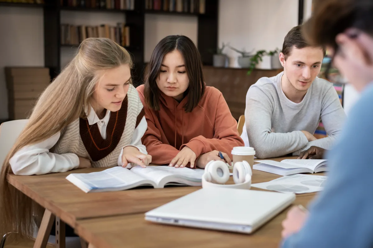 Students with books and notebooks open