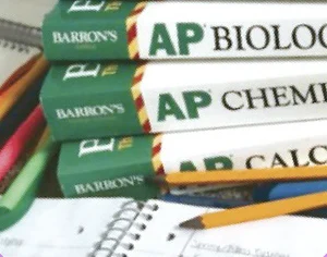 AP Biology, AP Chemistry, and AP Calculus exam prep books stacked with a pencil and notebook