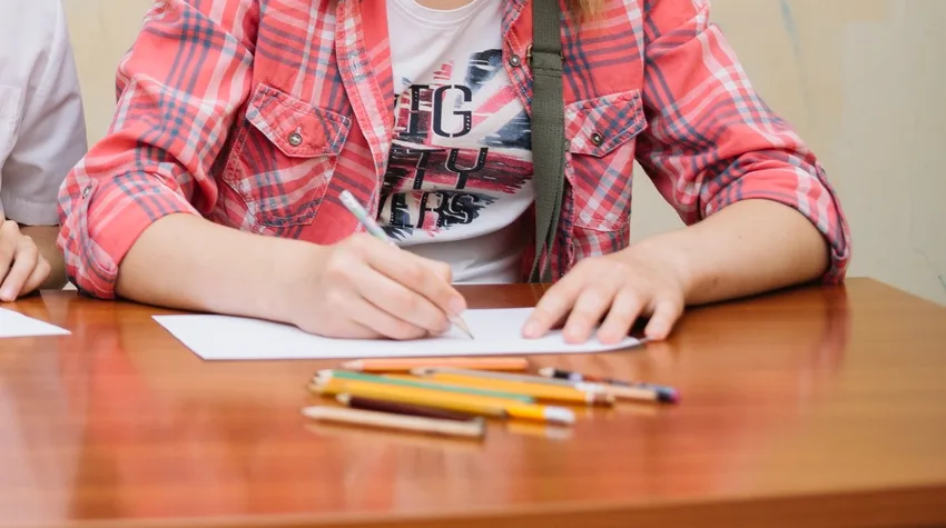 A hand writing on paper