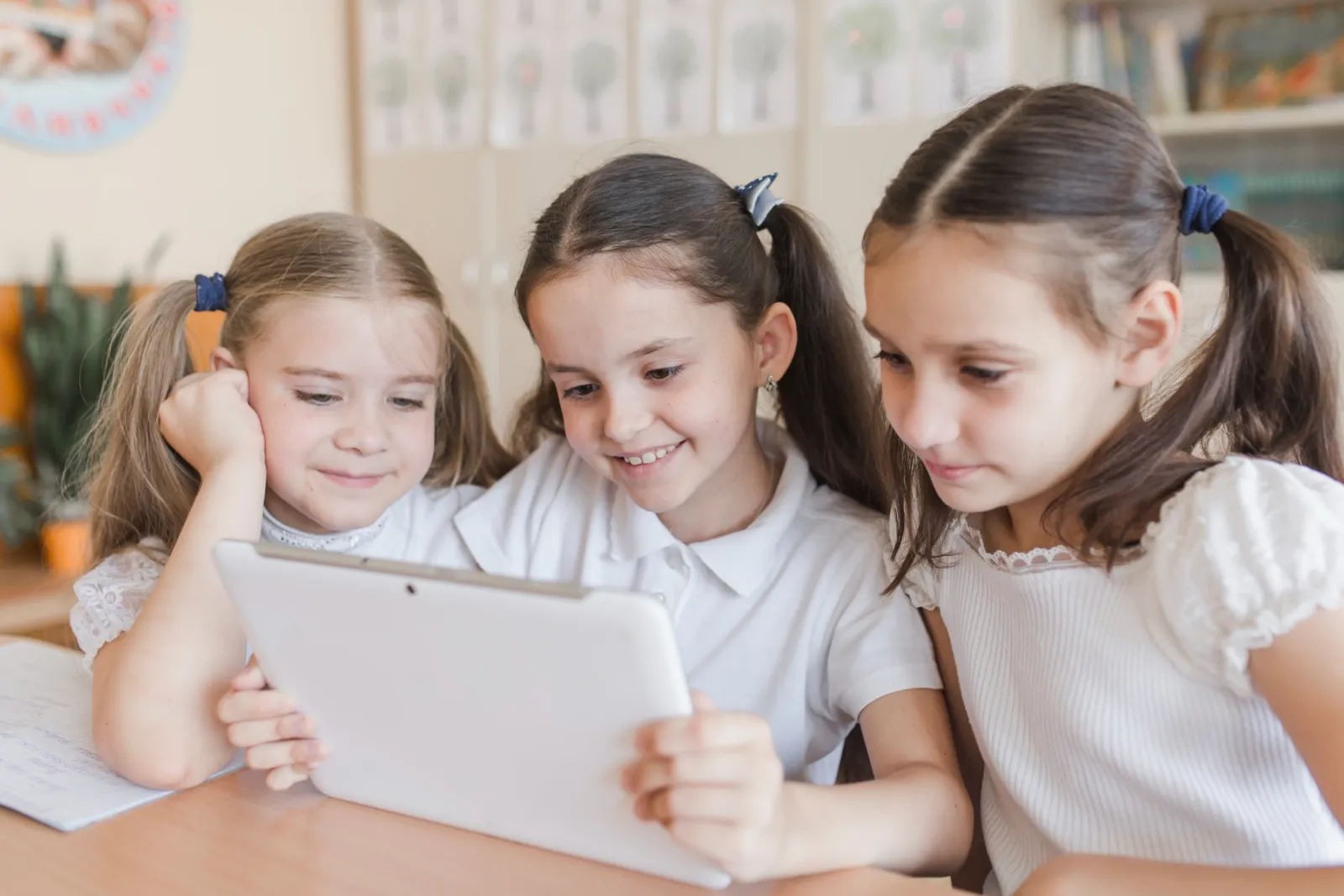 Elementary school girls looking at a tablet together